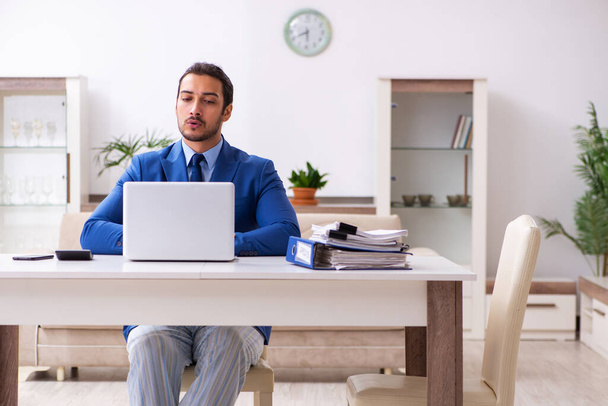 Young male employee working from house in self-isolation concept - Photo, image