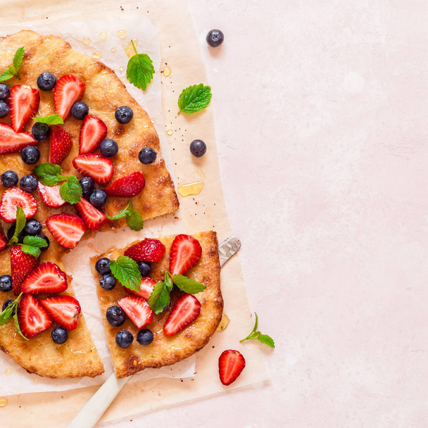 Summer Flatbread with Fresh Strawberries, Blueberries and Honey, Colors of American Flag for Independence Day 4th July, square, copy space for your text - Fotó, kép