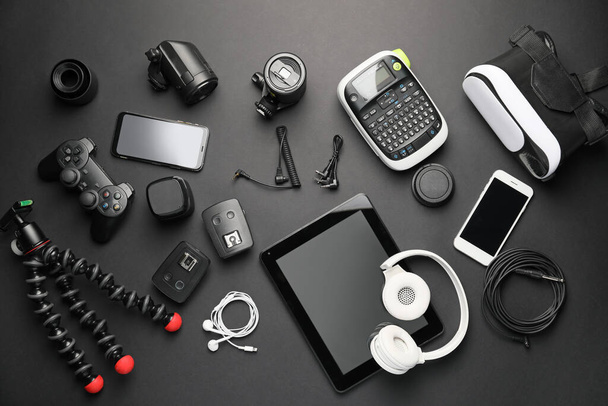 Different modern devices on dark background - Photo, Image