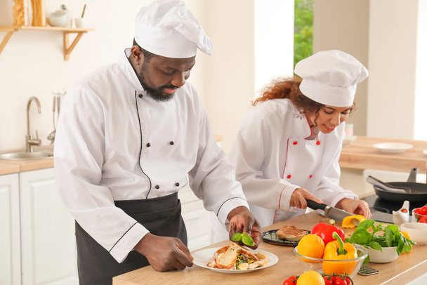 African-American chefs cooking in kitchen - Foto, Bild