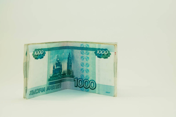 千ルーブル紙幣が白い背景に立っている - 写真・画像