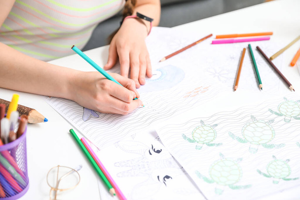 Young woman coloring picture at home, closeup - Photo, Image