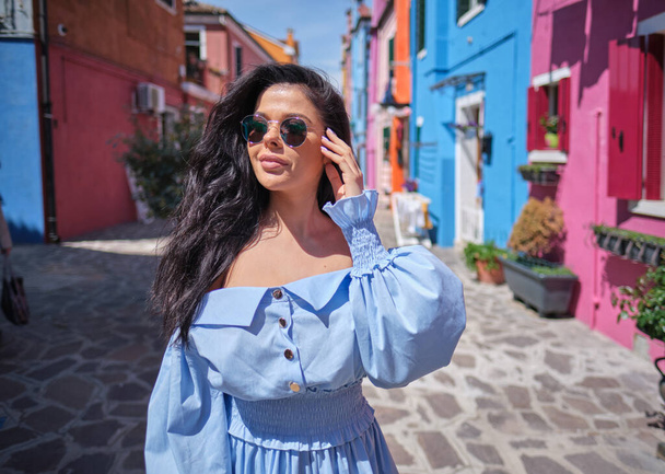 elegant, fashionable girl with glasse stay in the street , in a romantic Burano,Italy - Foto, Imagem