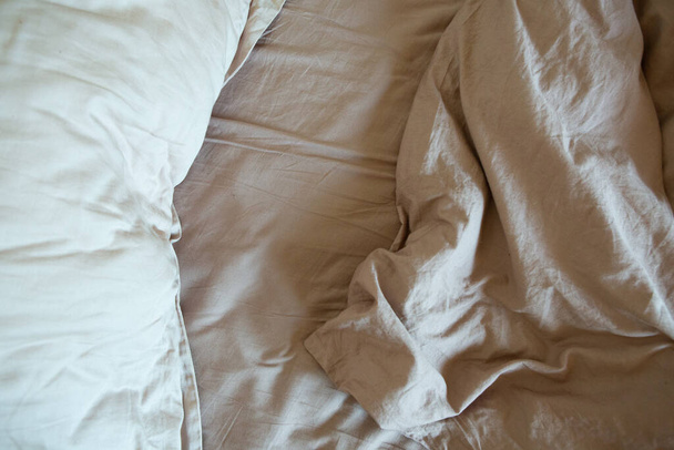 wrinkled sheet pillows and blanket on the bed home textile texture - 写真・画像