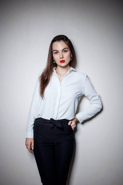 Portrait of young woman with long black hair in business wear. - Foto, afbeelding