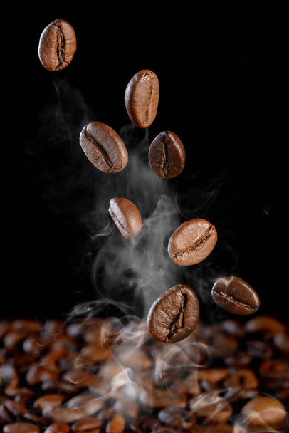 falling coffee beans. Coffee beans fall on the table. - Photo, Image
