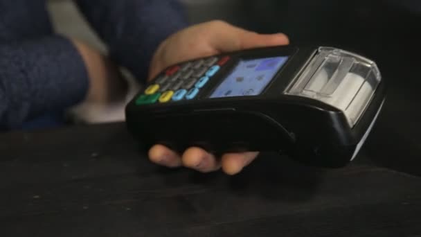 Primer plano joven pagando por la orden con tarjeta de crédito NFC tecnología utilizando terminal bancaria - Metraje, vídeo