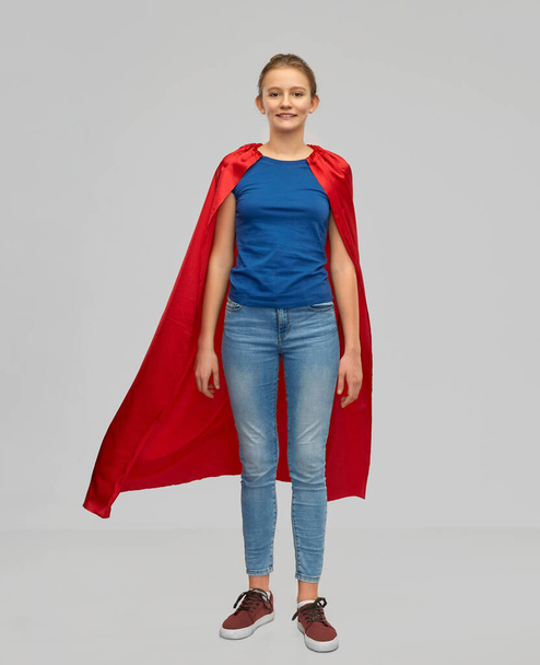 smiling teenage girl in red superhero cape - Фото, зображення