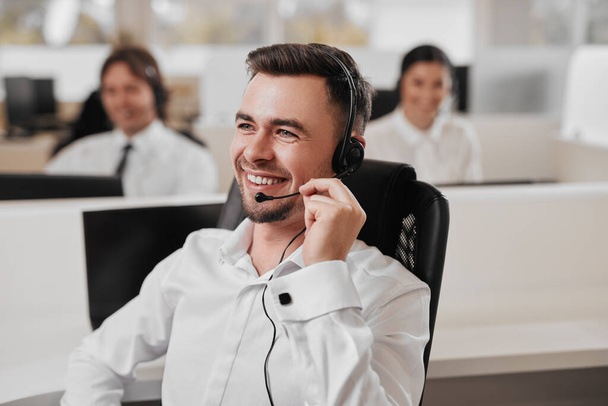 Happy man doing telemarketing in office - Foto, Imagem
