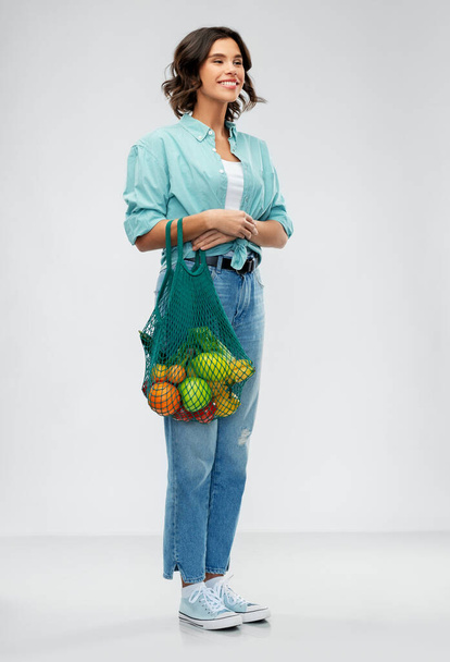 happy smiling woman with food in reusable net bag - Fotografie, Obrázek