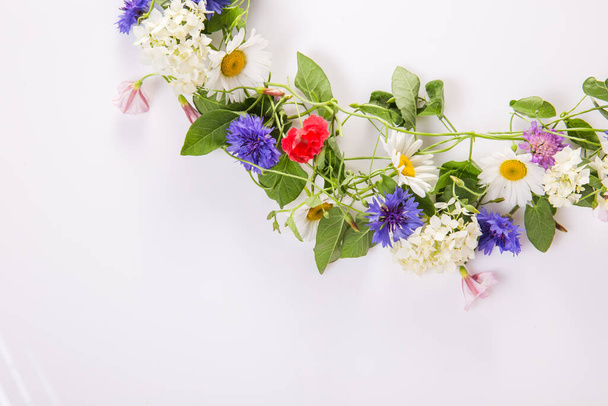 Wreath of wildflowers isolated on a white background. - 写真・画像