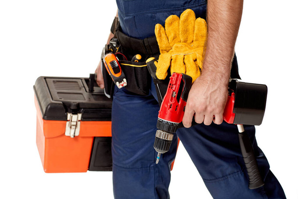 repairman holding cordless screwdriver and tool box. - Foto, Imagen