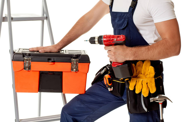 repairman holding cordless screwdriver and tool box. - Фото, зображення