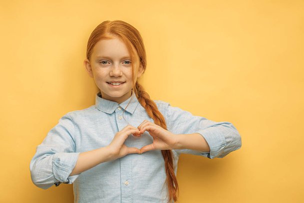 nice caucasian girl show heart gesture, made from hands - Photo, image