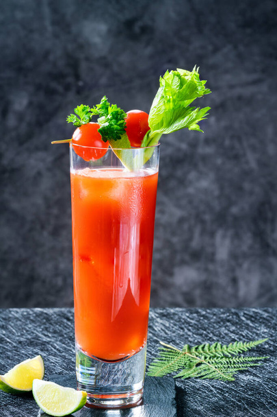 Bloody Mary cocktail with vodka and tomato juice with garnishes - alcoholic party drink - Foto, Imagen