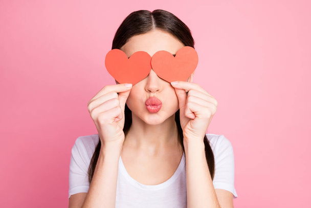 Close-up portrait of her she nice attractive lovely lovable flirty cheerful straight-haired girl closing eyes with red heart sending air kiss isolated over pink pastel color background - Фото, изображение