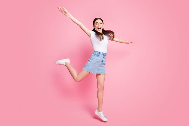 Full length body size view of her she nice attractive lovely charming pretty slender cheerful cheery girl jumping having fun walking isolated over pink pastel color background - Zdjęcie, obraz