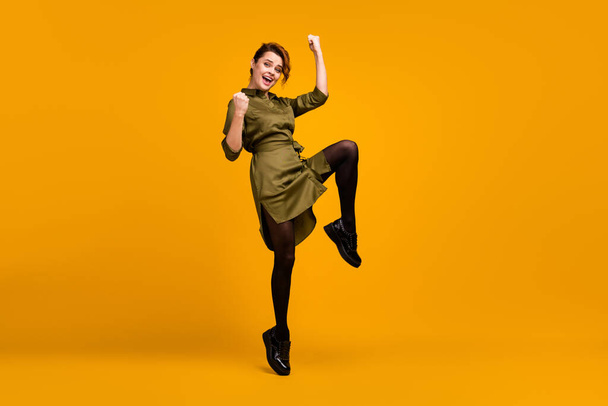 Full length body size view of her she nice-looking fashionable attractive lovely lucky cheerful cheery girl jumping having fun good news isolated on bright vivid shine vibrant yellow color background - Φωτογραφία, εικόνα