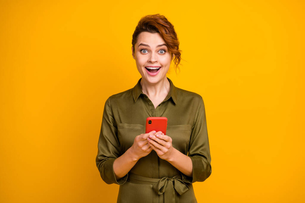 Portrait of her she nice attractive lovely charming cheerful cheery glad amazed wavy-haired girl using gadget fast speed connection 5g isolated on bright vivid shine vibrant yellow color background - Fotoğraf, Görsel