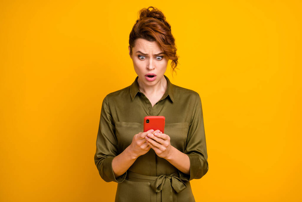 Portrait of her she nice attractive lovely outraged worried wavy-haired girl using device browsing reading fake news isolated on bright vivid shine vibrant yellow color background - Фото, изображение