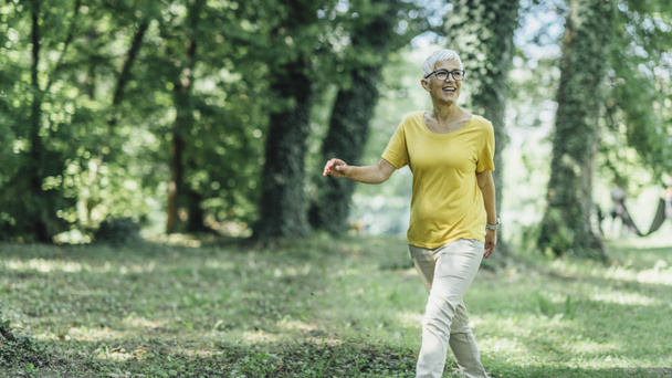 Intermittent walking workout, mature woman exercising, losing weight during menopause - Fotó, kép
