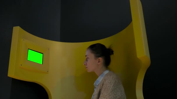 Woman looking at little blank digital green display - green screen concept - Footage, Video