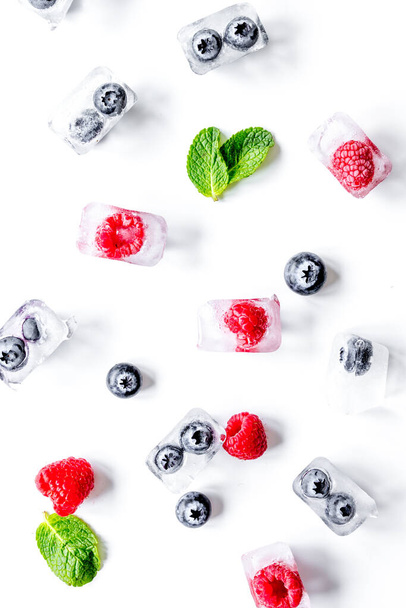fresh berries with mint in ice cubes on white background top view - Fotoğraf, Görsel