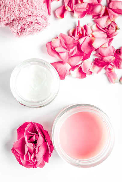 rose flower and cream for nail care in spa on white background top view - Foto, immagini