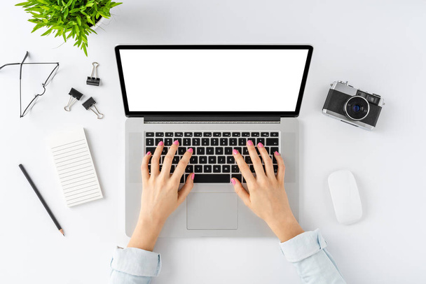 Elegant workspace. Young woman hands using laptop with blank display. Top view - Fotó, kép
