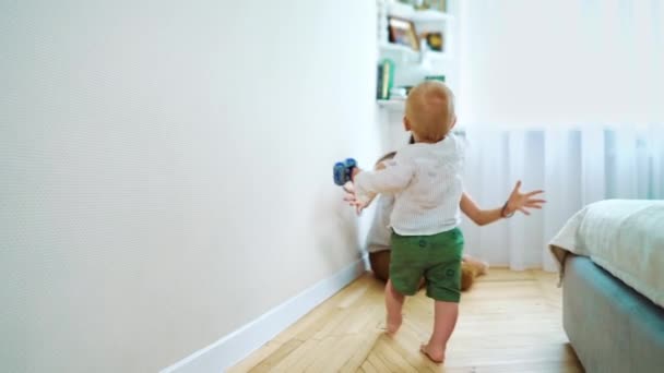 Cute toddler walking to mother and falling down - Materiał filmowy, wideo