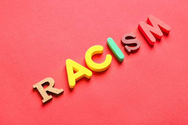 Word RACISM on color background - 写真・画像