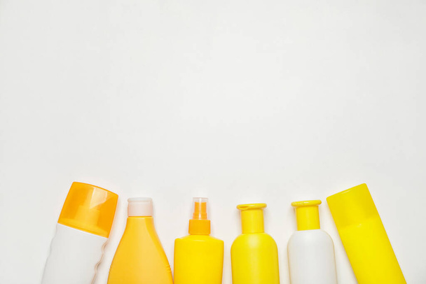 Bottles of sunscreen on white background - Photo, Image