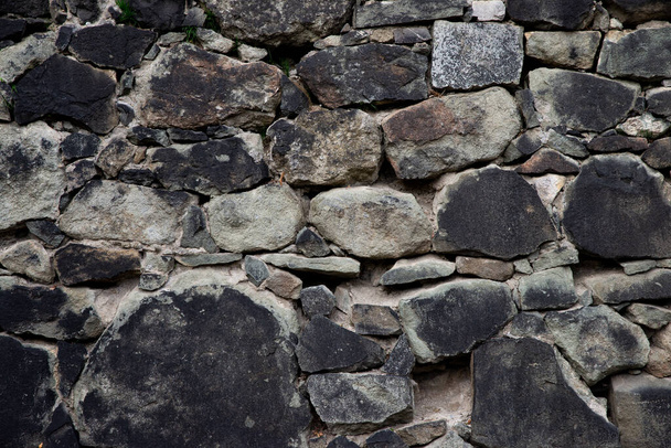 Texture of stone wall made of grey stones - Foto, imagen