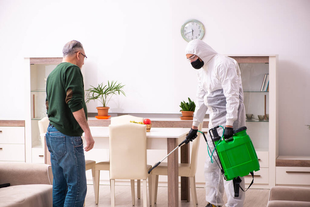 Young male sanitizer and old man indoors - Photo, Image