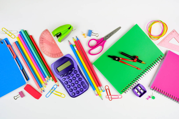 School supplies scene. Flat lay over a white background. Back to school concept. - Photo, Image