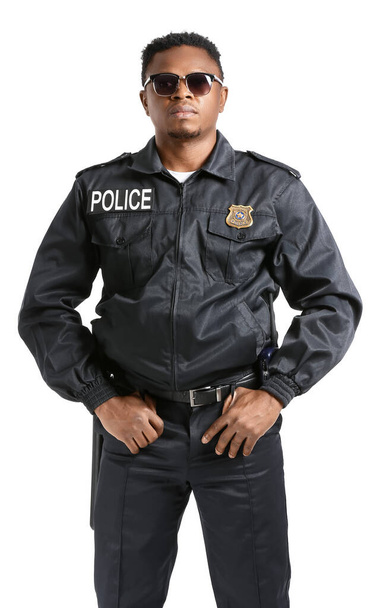 Aggressive African-American police officer on white background - Photo, Image
