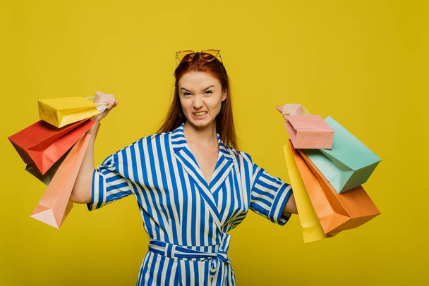 Stylish trending template for advertising. Funny girl drags a large number of shopping bags. The concept of a strong and independent woman. - Photo, image