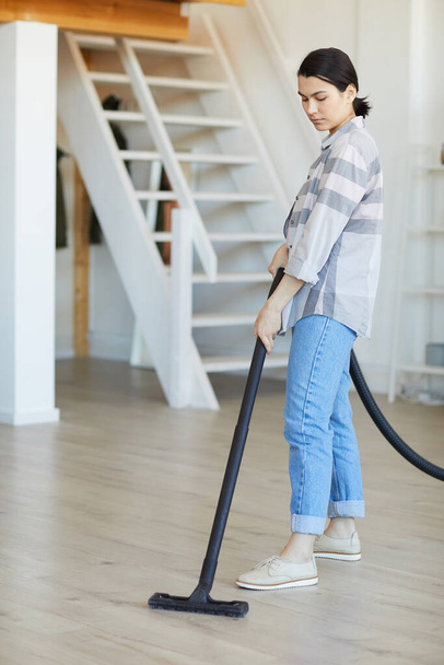 Housekeeper using vacuum cleaner - Photo, Image