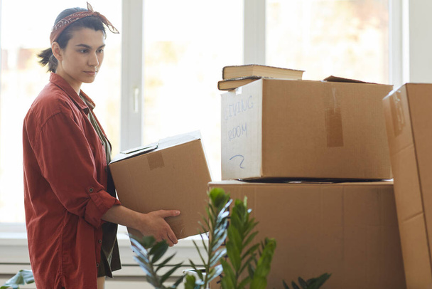 Woman carrying things in box - Photo, Image