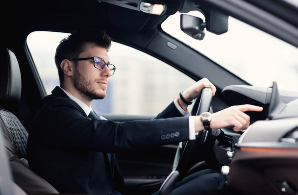 Businessman In Specs Sitting In New Auto Checking Dashboard - Fotó, kép