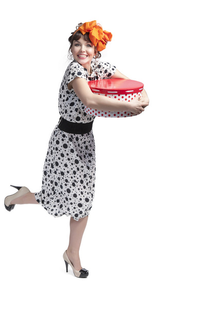 Happy girl holding gift box with red polka dots - Fotoğraf, Görsel