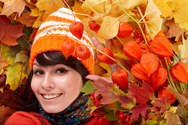 Girl in autumn orange hat, leaf group, flower. - Photo, Image
