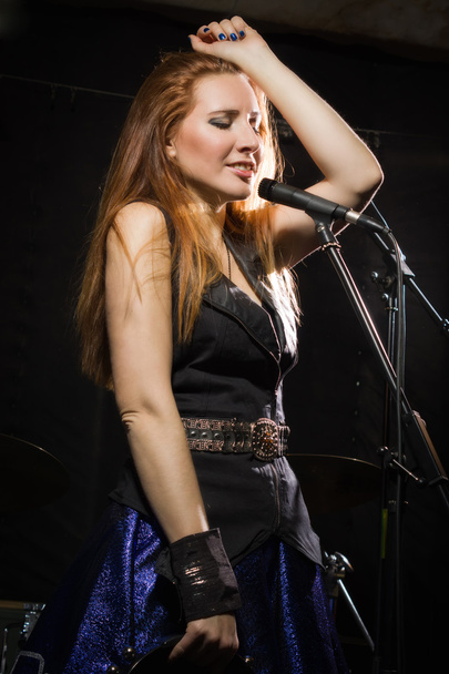 Rock star girl singing in a studio - Photo, Image