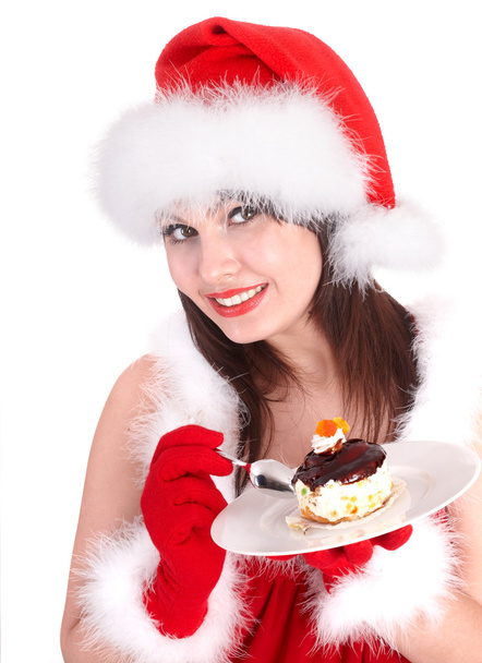Різдвяна дівчина в червоному капелюсі Санта і торт на тарілці
. - Фото, зображення