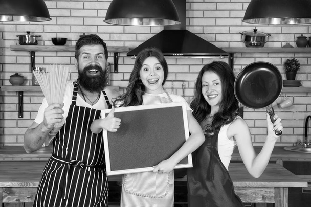 happy family day. friendly family in kitchen. healthy food at home. kid chef cook dinner. copy space. do everything together. everyday winners. Mother and father cooking with daughter. Organic food - Fotografie, Obrázek