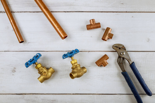 Brass gate valve on wooden background, monkey wrench brass plumbing fittings - Photo, Image
