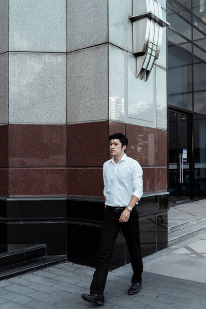 Mature asian business man on white formal shirt walking on the street outside the building. - Foto, immagini
