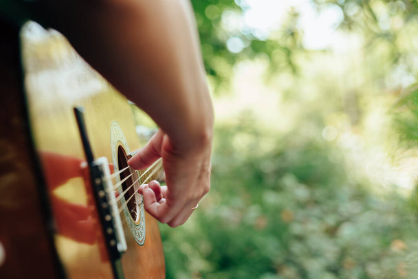 woman's hands playing acoustic guitar have fun outdoor, close up. - Foto, immagini