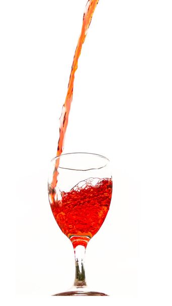 Red wine poured in a glass isolated on white - Photo, Image