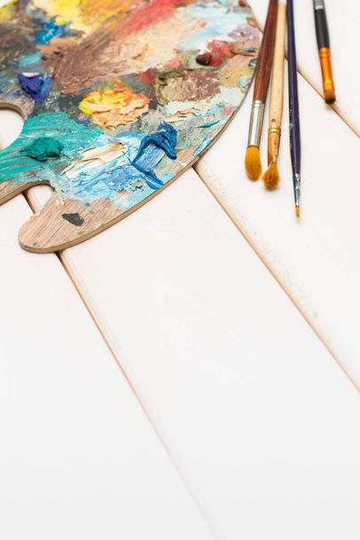 Artist desktop with paints and brushes - Zdjęcie, obraz